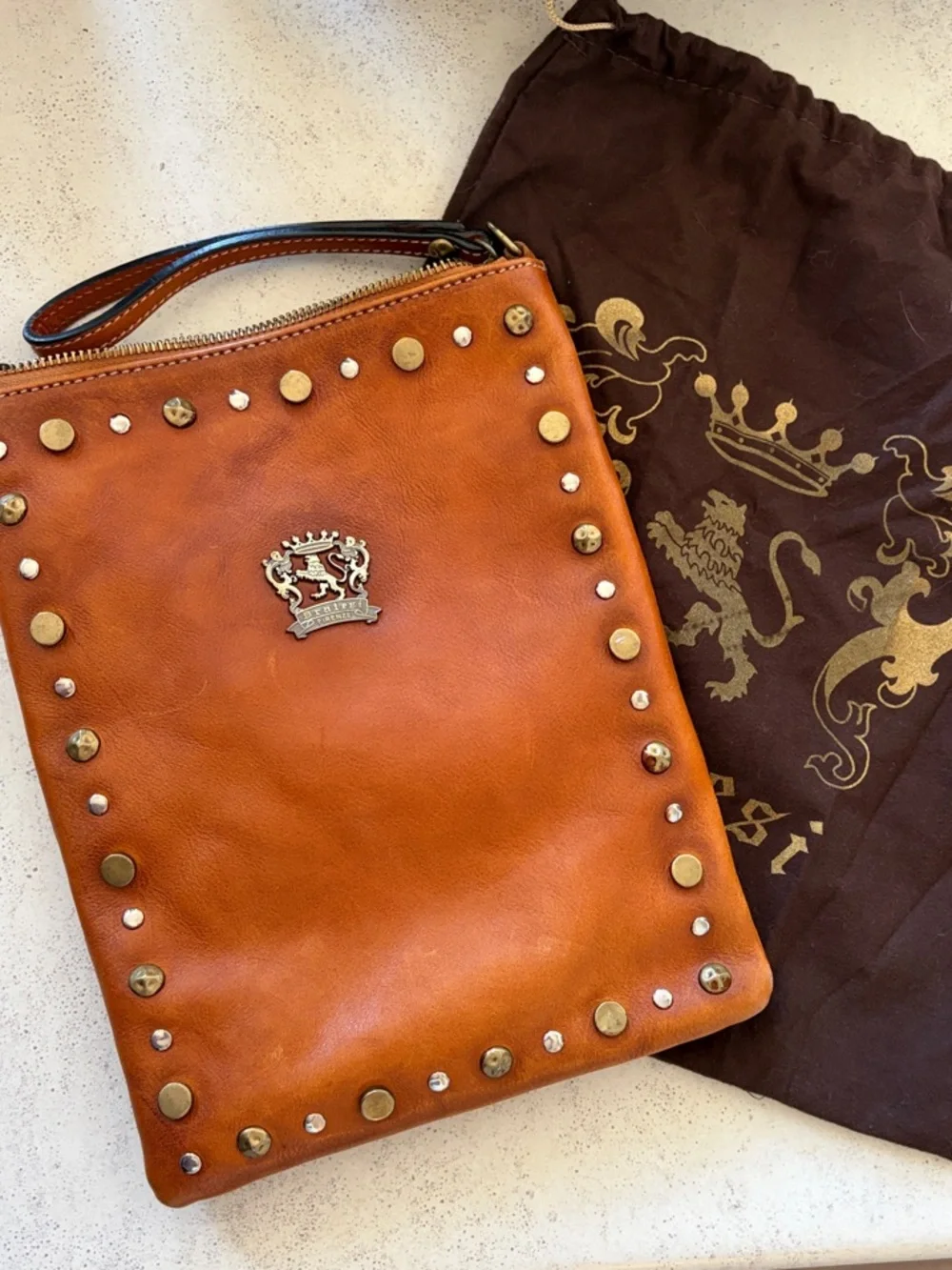 Studded Leather Wristlet Clutch in Cognac with Crest Emblem